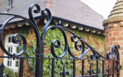 Wrought iron gates closeup, closed black metal gates to a country manor house, UK