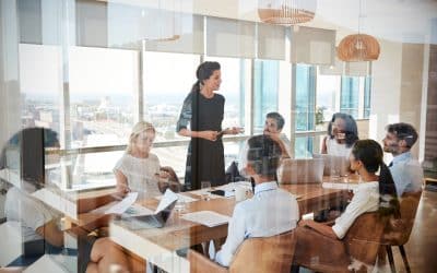 Businesswoman,Leads,Meeting,Around,Table,Shot,Through,Door