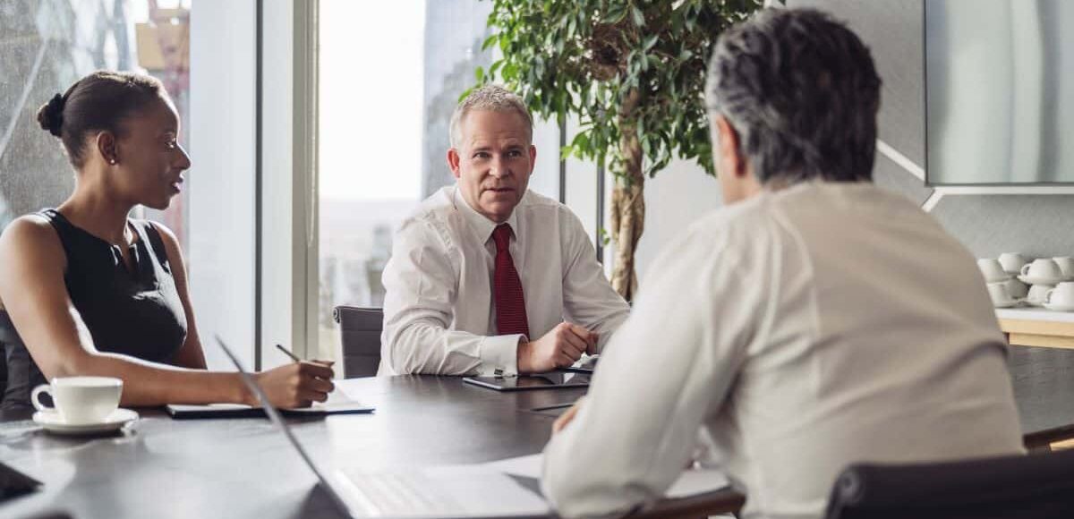 Meeting between three business people