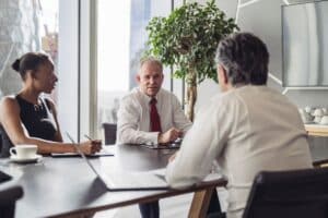 Meeting between three business people