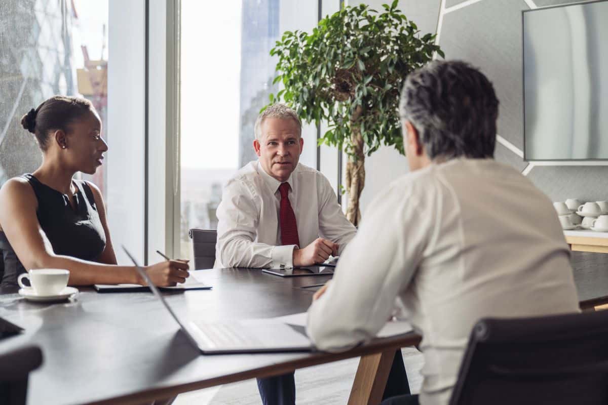 Meeting between three business people