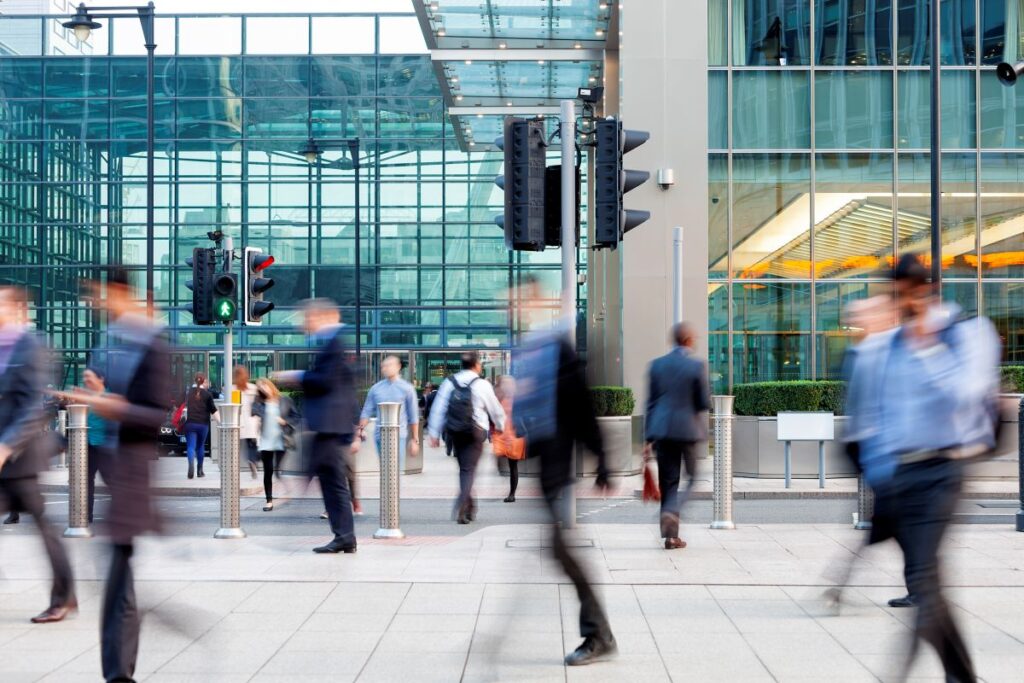 Commuters walking in front of an office building