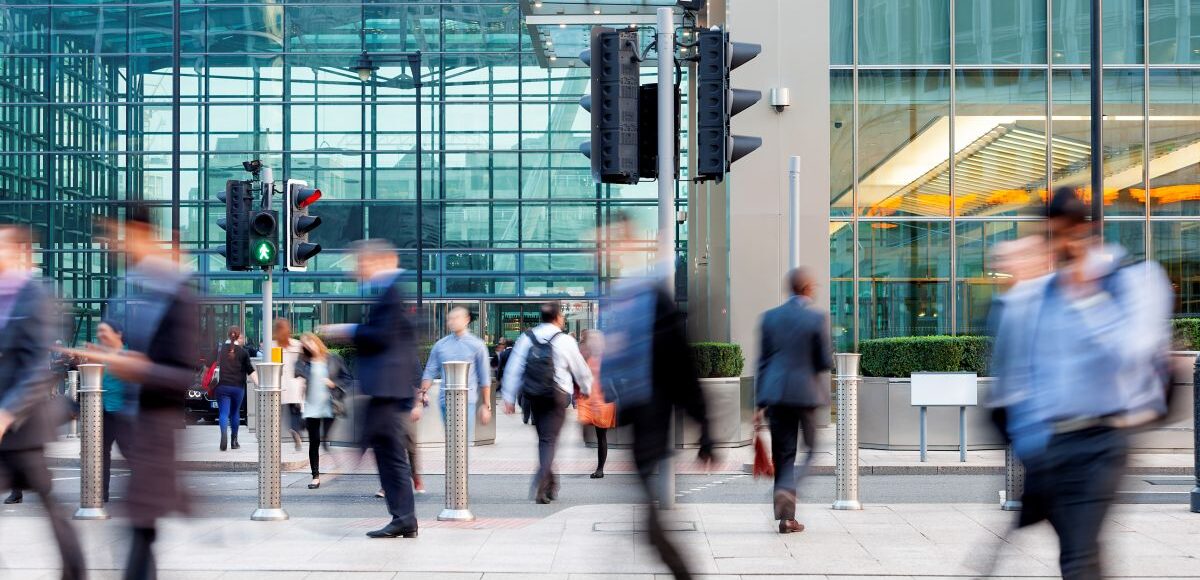 Commuters walking in front of an office building