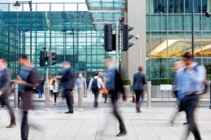 Commuters walking in front of an office building