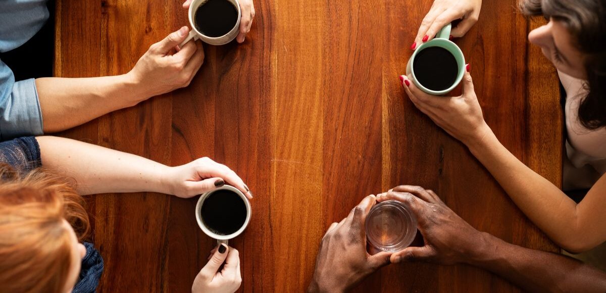 Adults talking over coffee