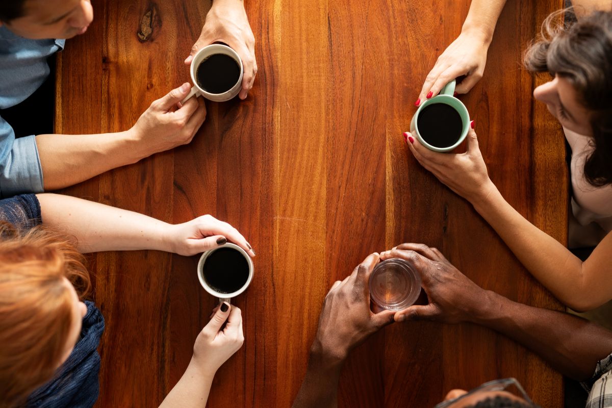 Adults talking over coffee