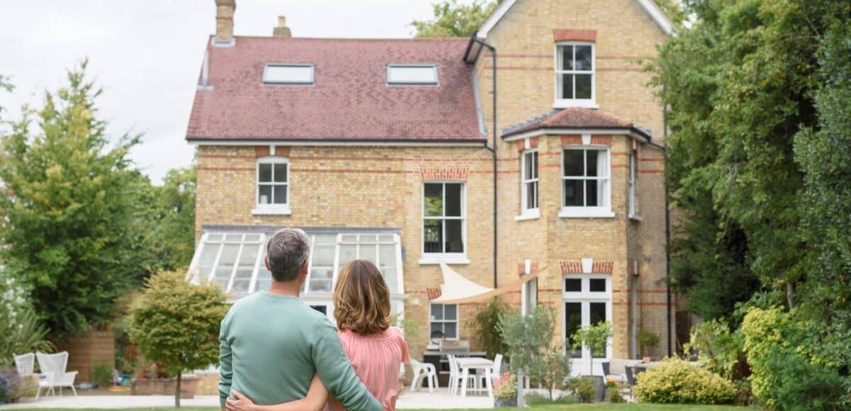 Couple standing in front of a house