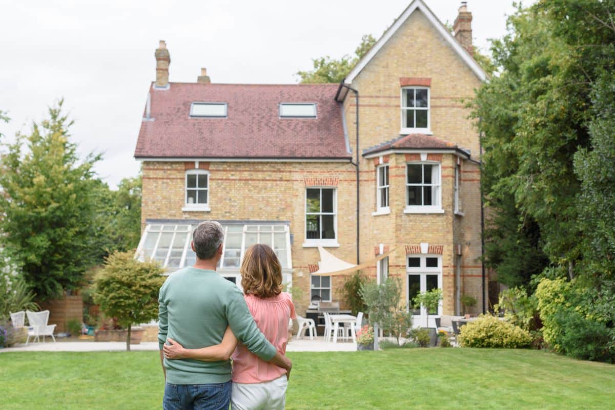 Couple standing in front of a house